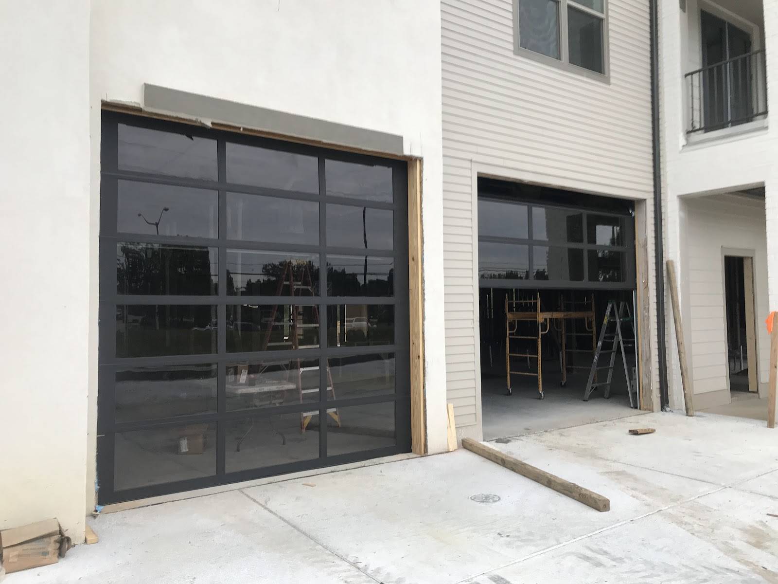 Black-frame full-view glass garage doors on a new building at the Inlet in Ocean Springs.